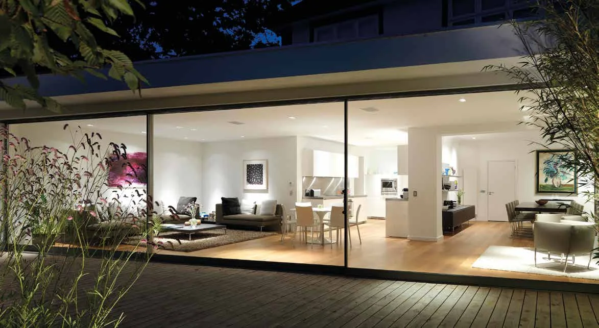 Oversized sliding glass doors connecting a contemporary home with its garden terrace
